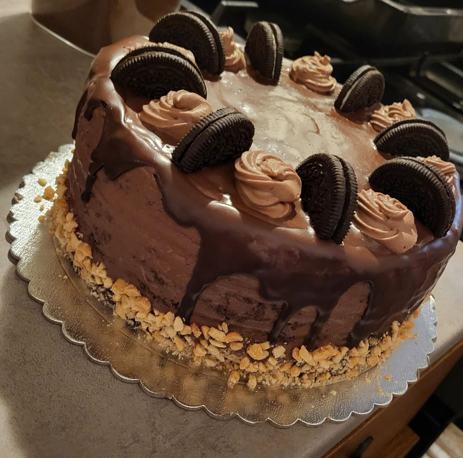 Tort de ciocolată cu rozete de cremă, biscuiți Oreo și margine cu migdale